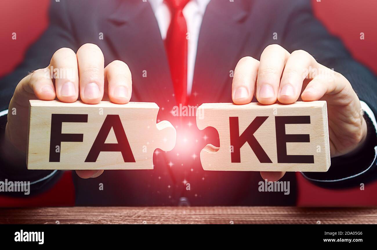 A man breaks a fake puzzle. Exposing fake news and false info. Debunking myths. Investigation of doubtful facts, information hygiene. Timely refutatio Stock Photo