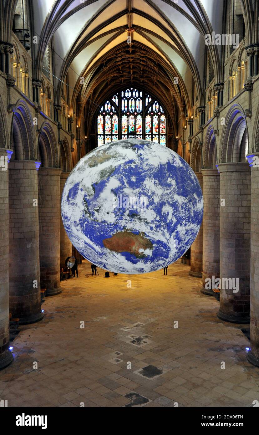 He has the whole world in his hands or more specifically the whole earth in Gloucester Cathedral.   A touring artwork by UK artist Luke Jerram, 'Gaia' Stock Photo