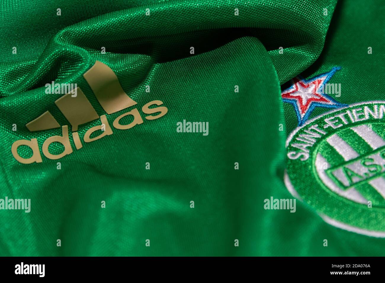 Gold Adidas Logo next to AS Saint-Etienne logo on the front of a green  football shirt Stock Photo - Alamy