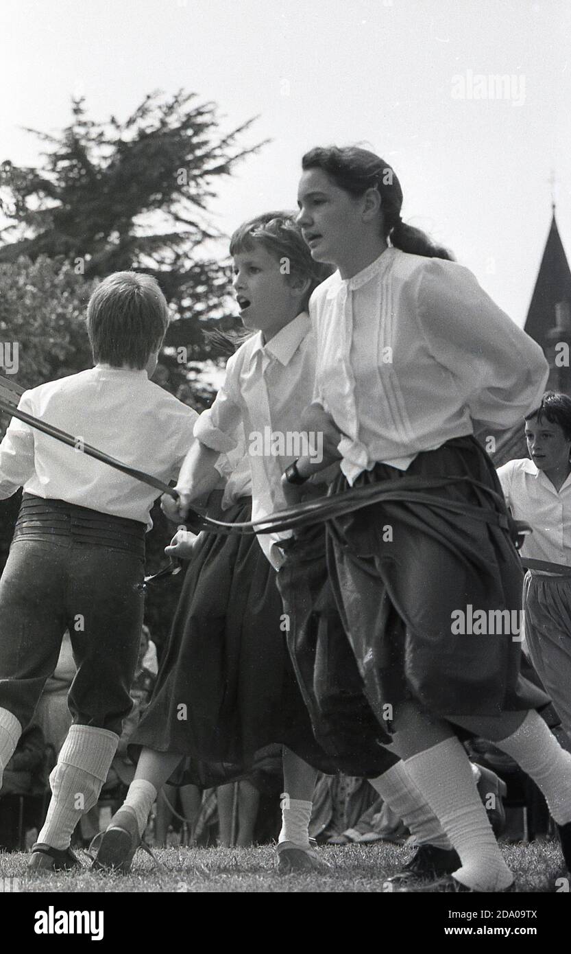 1987, youngsters in traditional costumes dancing at a county or agricultural show, Yorkshire, England, UK, doing a kind of morris dance, a traditional old English folk dance. Stock Photo