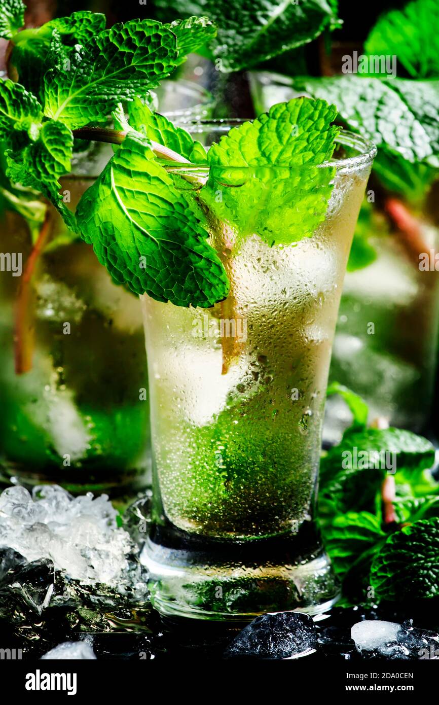 Green tea with ice, mint and white rum, dark background, selective ...