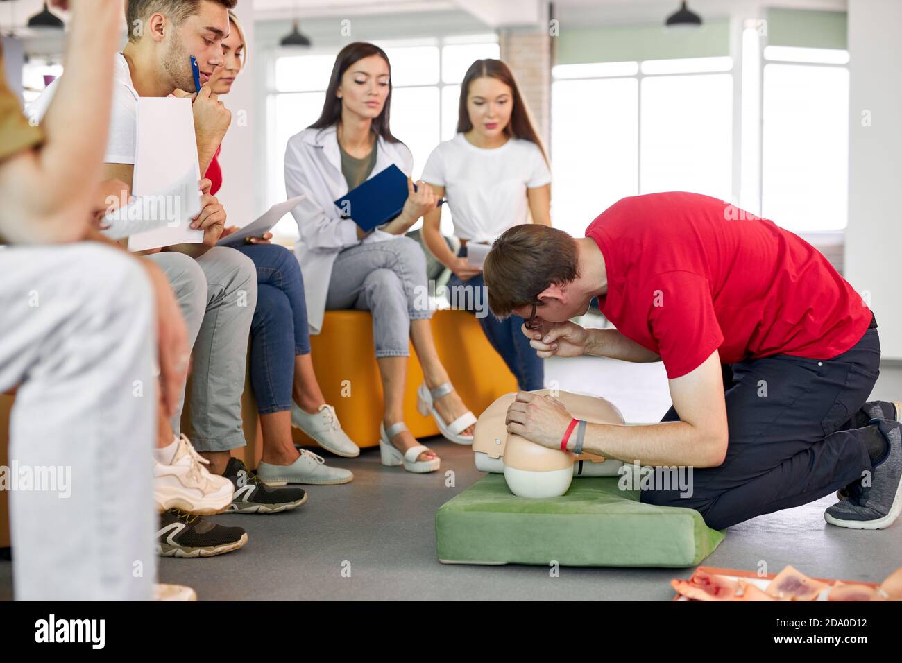 CPR class with young caucasian instructors speaking and demonstrating