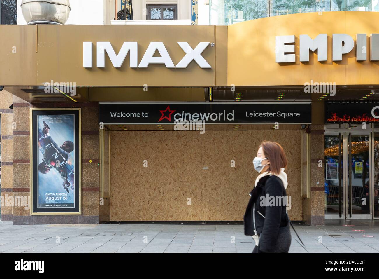 Pedestrian in face mask walks past IMAX theatre in Leicester Square, closed during the second national lockdown, London, 7 November 2020 Stock Photo