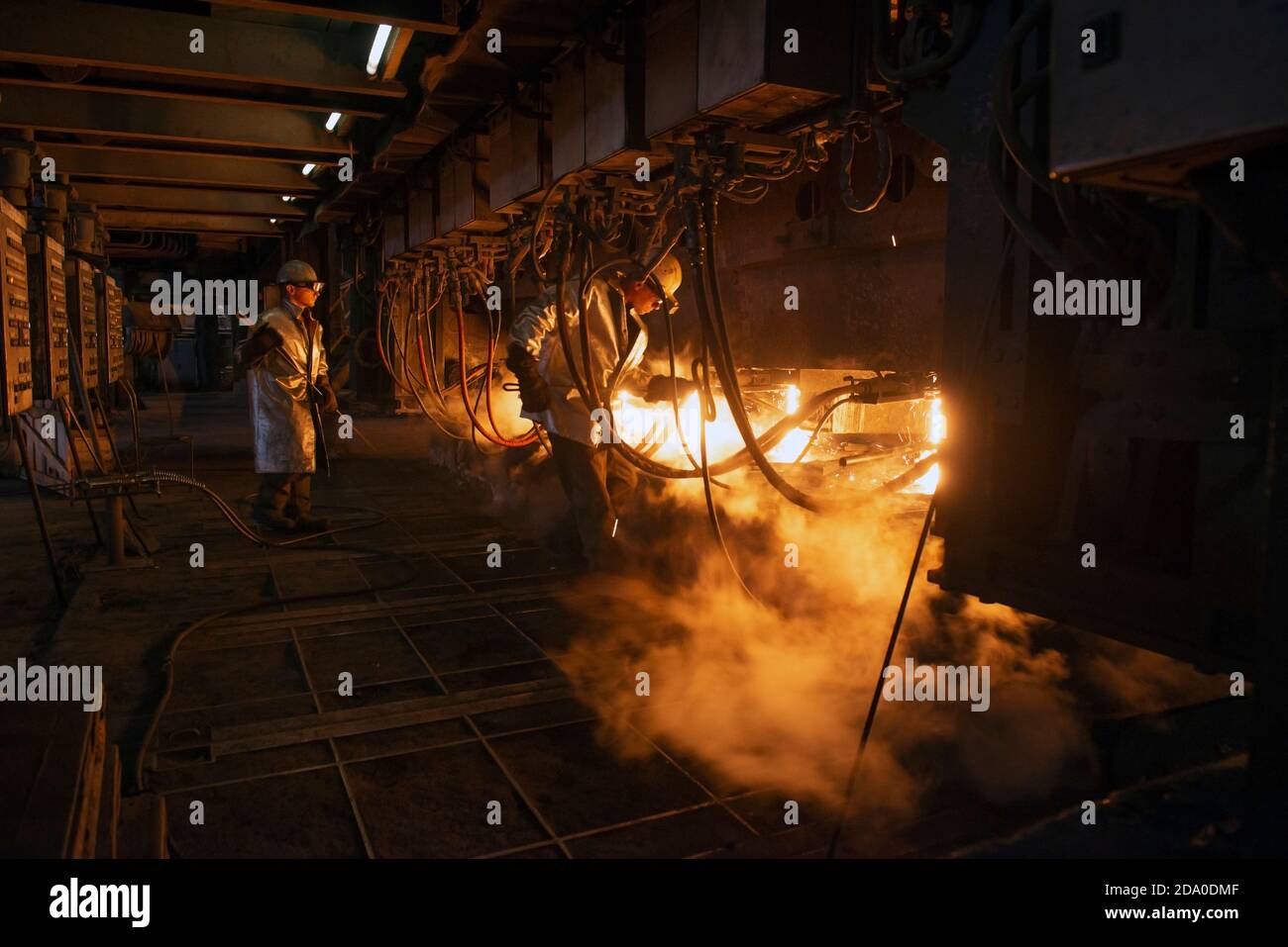 Steel production in electric furnaces. Sparks of molten steel. Electric arc furnace shop