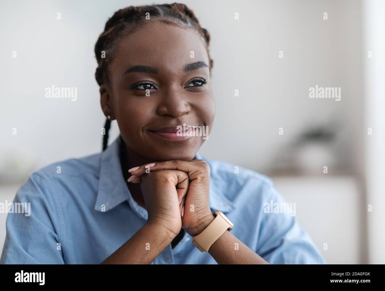 Closeup Portrait Of Dreamy Young Black Woman With Braids Looking Away Stock Photo