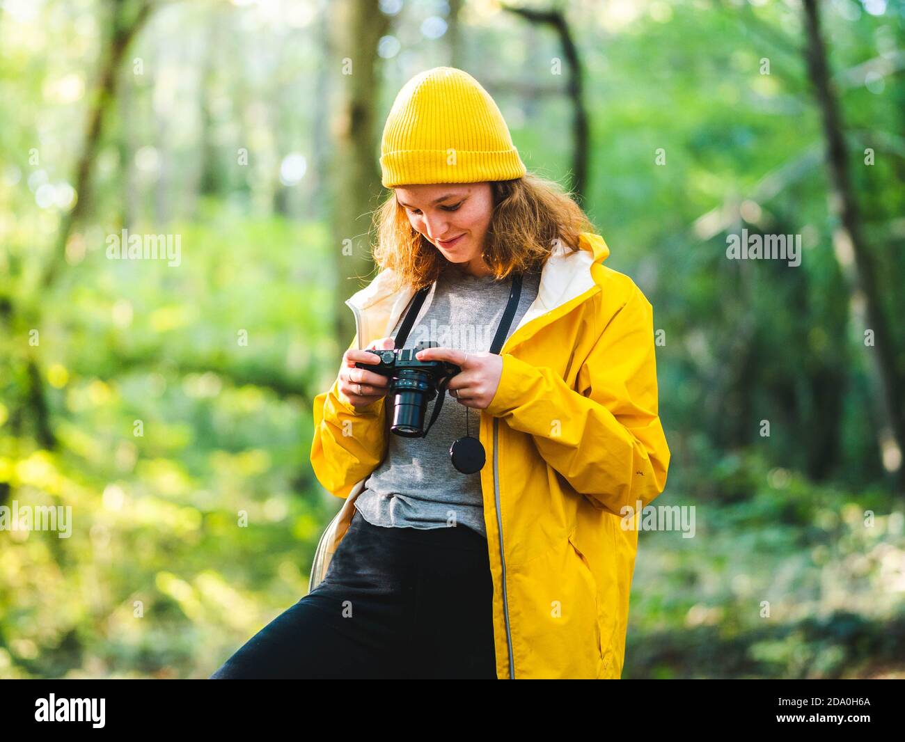 Cheerful woman in yellow raincoat hi-res stock photography and images ...