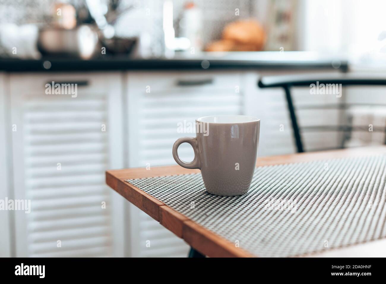 Hot cup of tea or coffee, cocoa on wood table in kitchen background