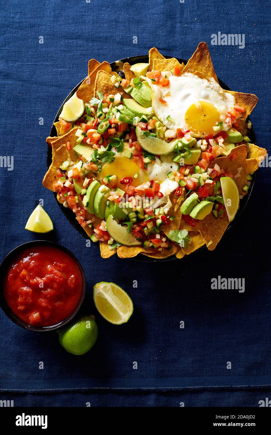 Chilaquiles mexican breakfast made of black beans, corn, tortilla chips