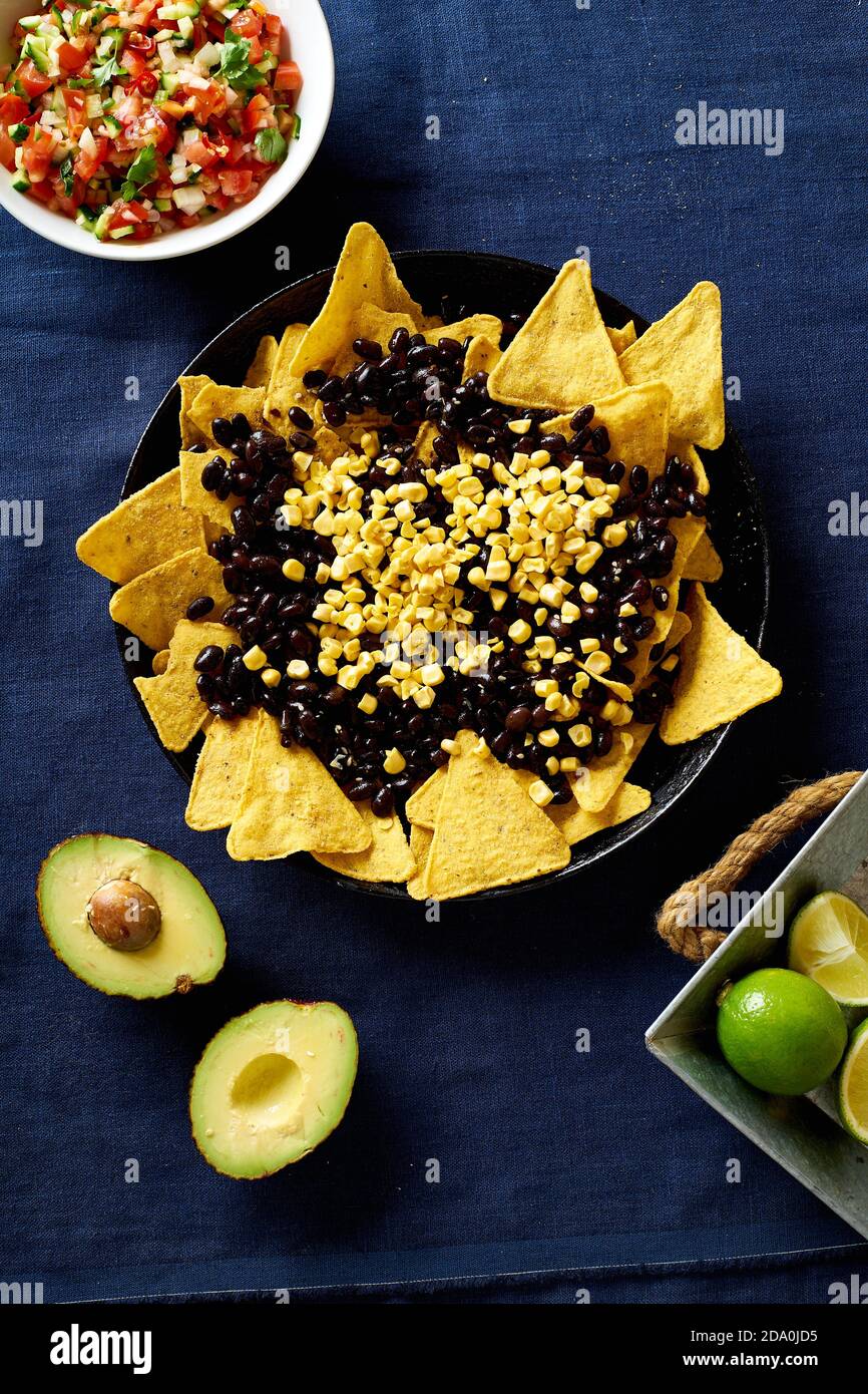 Cooking chilaquiles mexican breakfast made of black beans, corn