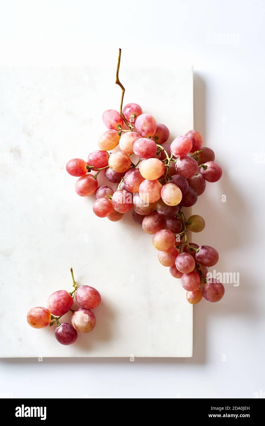 A cluster of pink muscatel grapes on white background Stock Photo