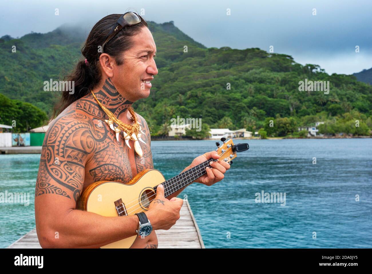 Local tattooed person playing the ukulele in Huahine, Society Islands,  French Polynesia, South Pacific Stock Photo - Alamy