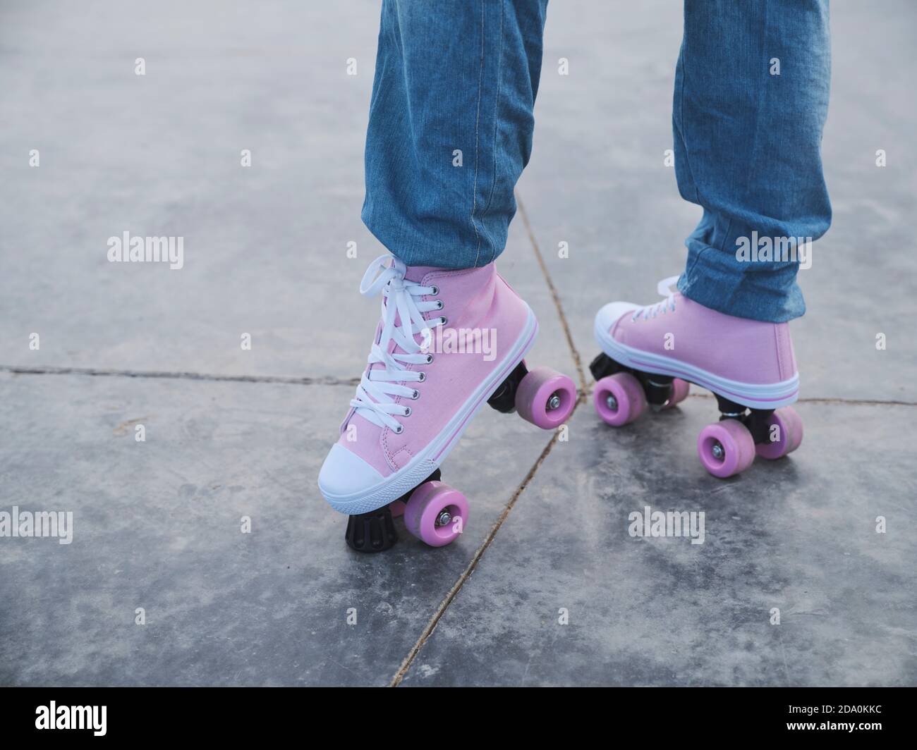 Roller skates. Legs of skater women, pink socks, sportswear. Young