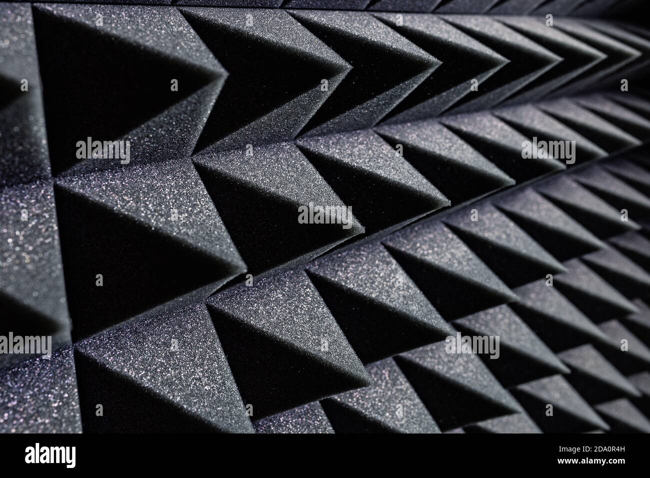 Textured background of wall with black geometric soundproof foam with ...