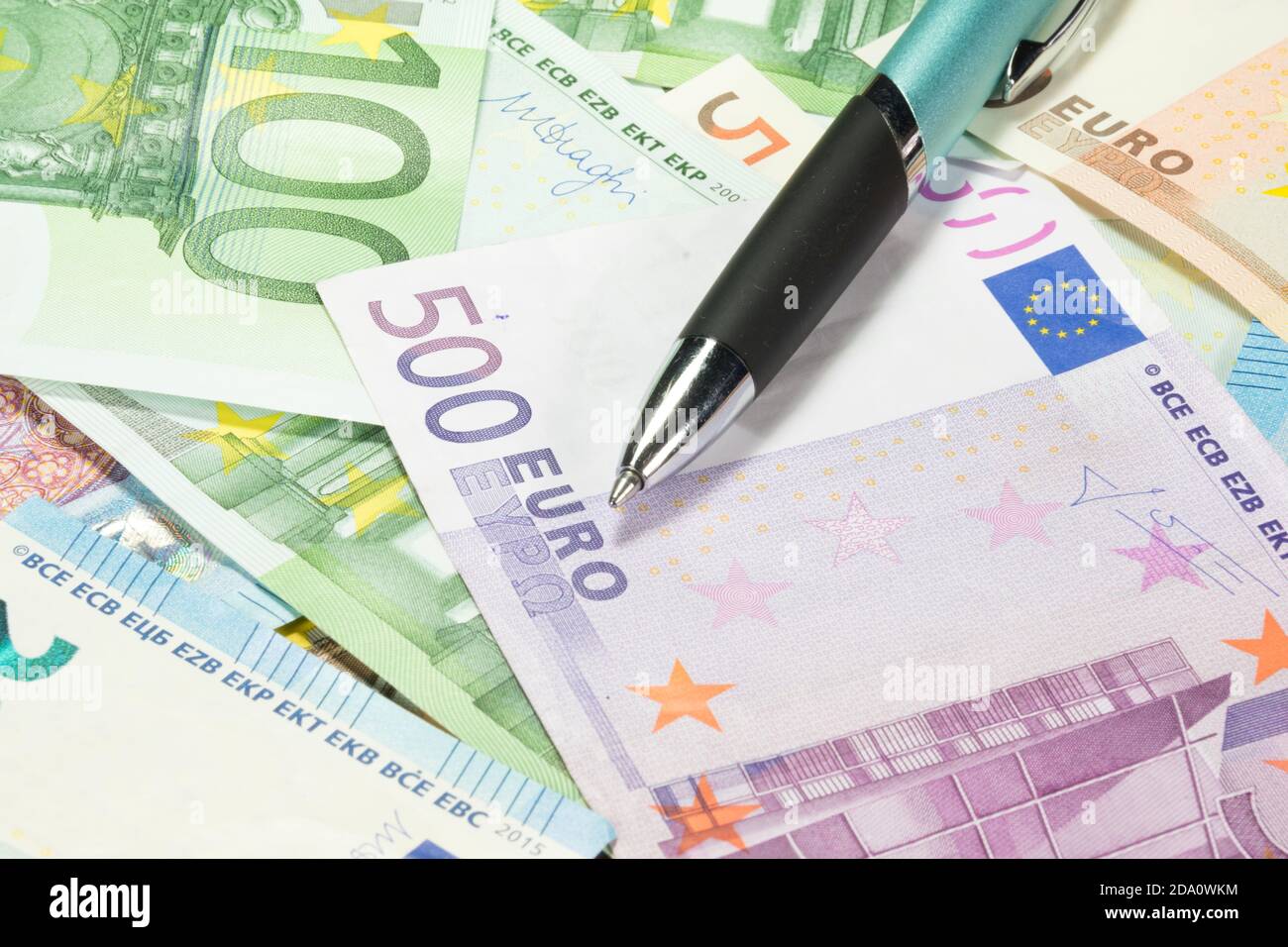 A ballpoint pen and lots of euro bills Stock Photo