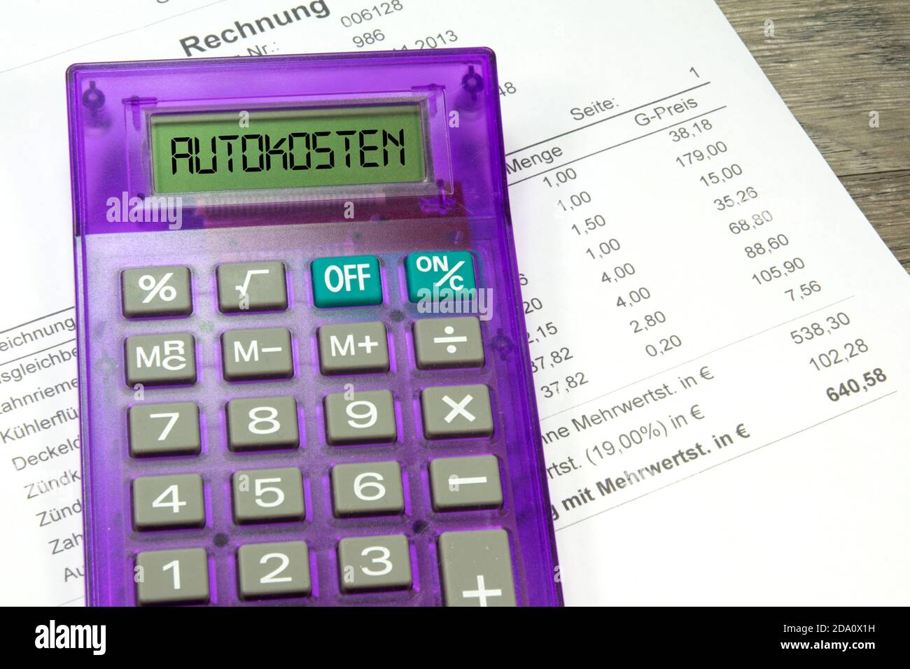 A workshop invoice and calculator for car costs Stock Photo