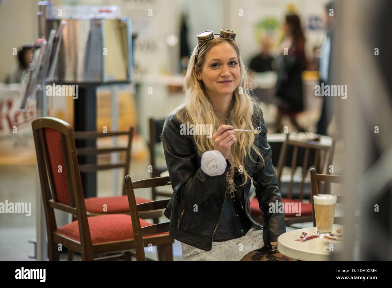 Woman at the convention trade center in Brno taking some time to have a coffee. BVV Brno Exhibition center. Czech Republic Stock Photo