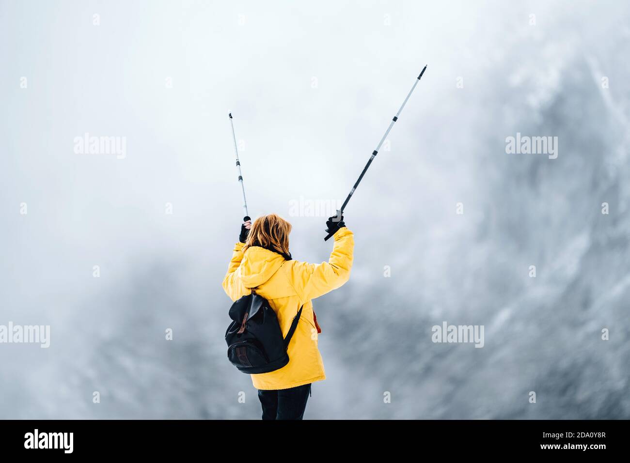 Full body back view of unrecognizable female hiker with backpack and ...