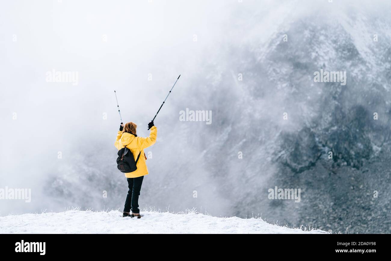Full body back view of unrecognizable female hiker with backpack and ...
