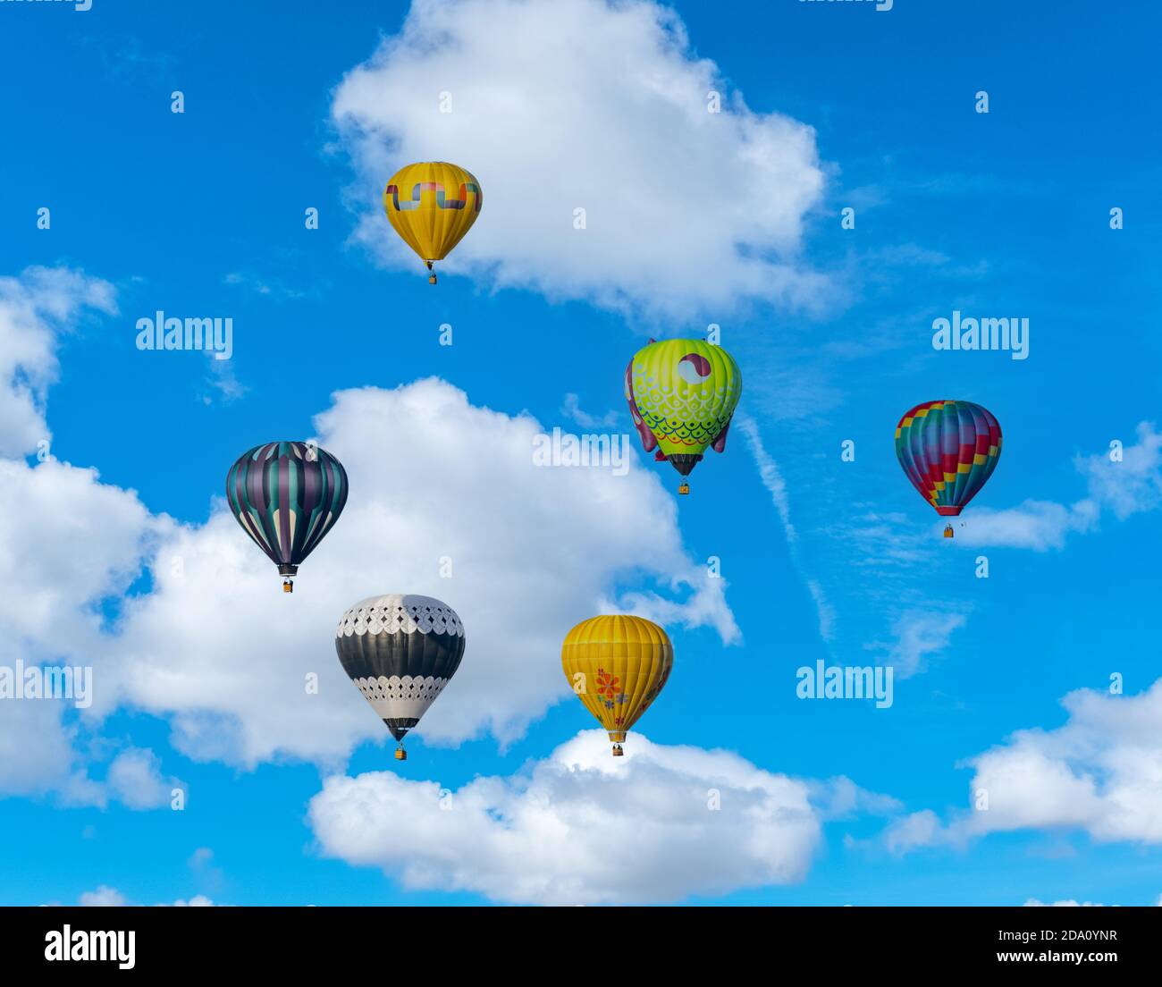 Blue sky with clouds and floating hot air balloons Stock Photo - Alamy