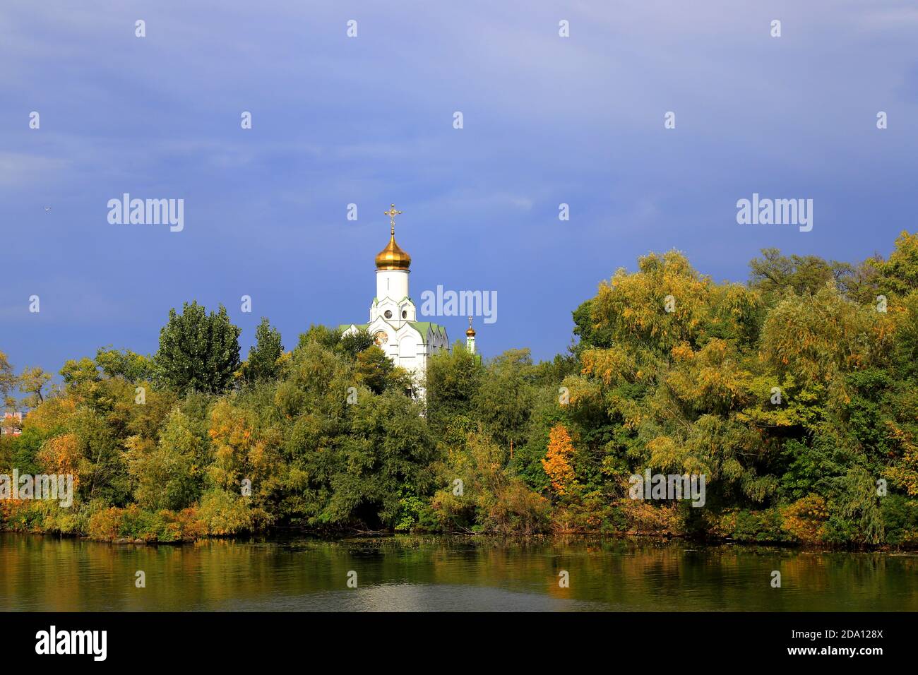 Beautiful autumn landscape on the Dnieper river, Christian church on the island among yellow trees, Ukraine city, Dnipro, Dnepropetrovsk, October Stock Photo