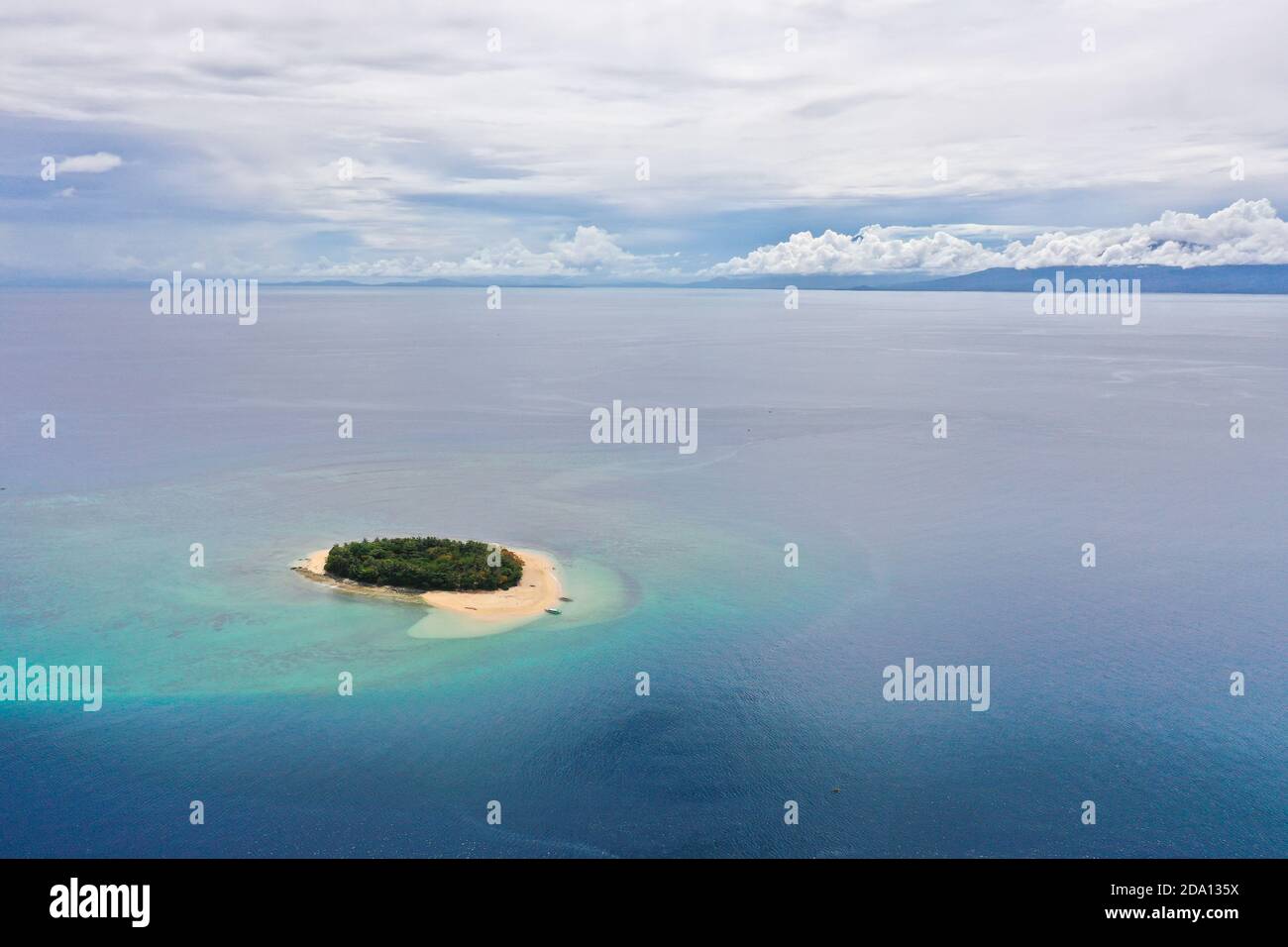 Small tropical island in the blue sea, top view. Summer and travel vacation concept. Rosa island, Philippines. Stock Photo
