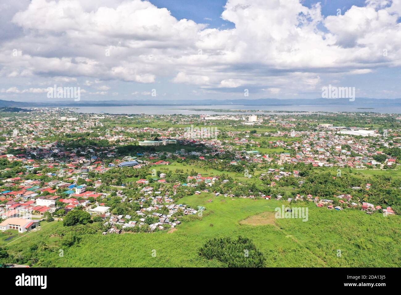 Tacloban, aerial view. Town and sky with cumulus clouds. Leyte Island, Philippines. Asian town by the sea. Summer and travel vacation concept. Stock Photo