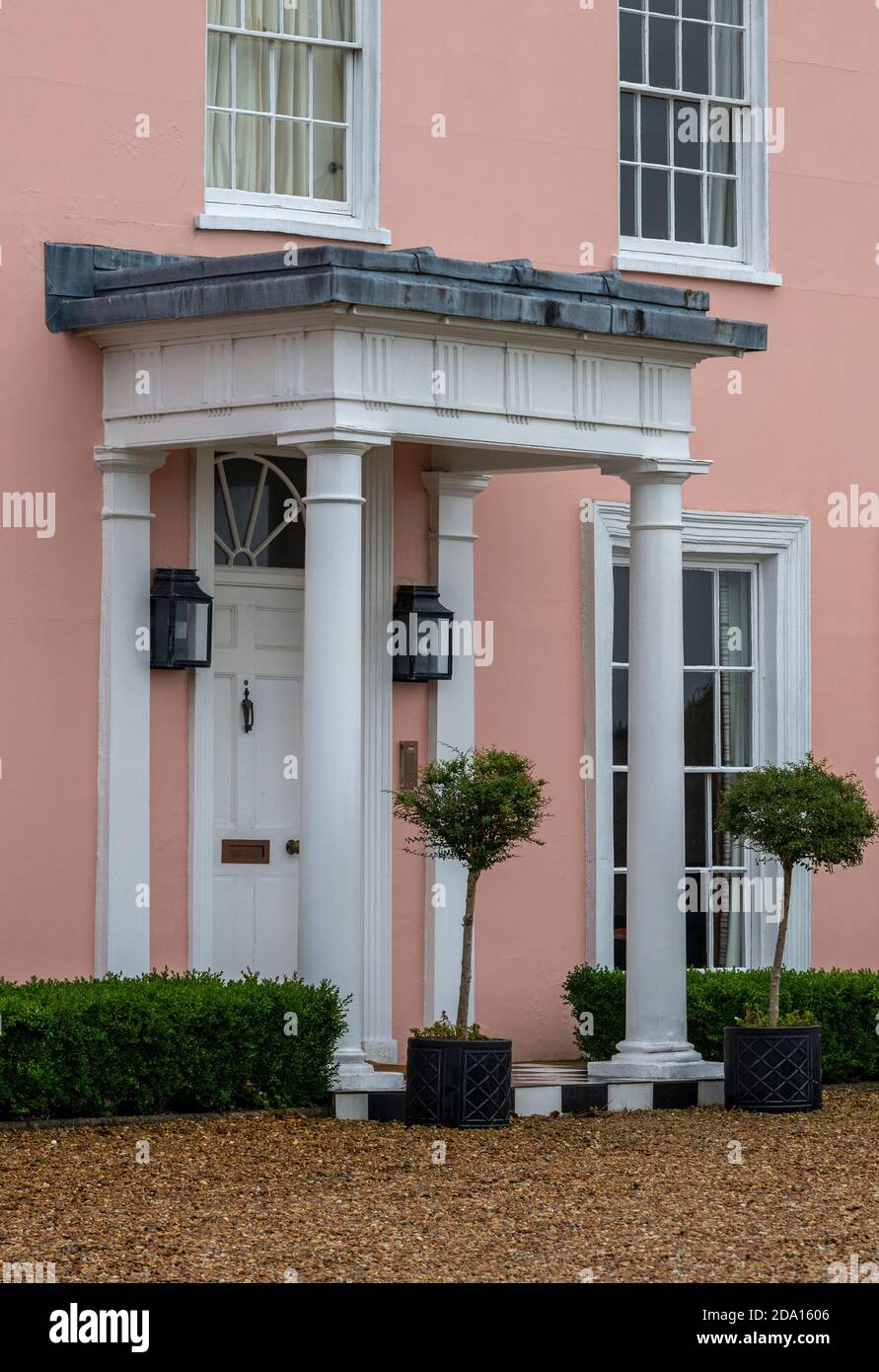 a traditional georgian front door and canopy with corinthian column holding a porch over the entrance Stock Photo