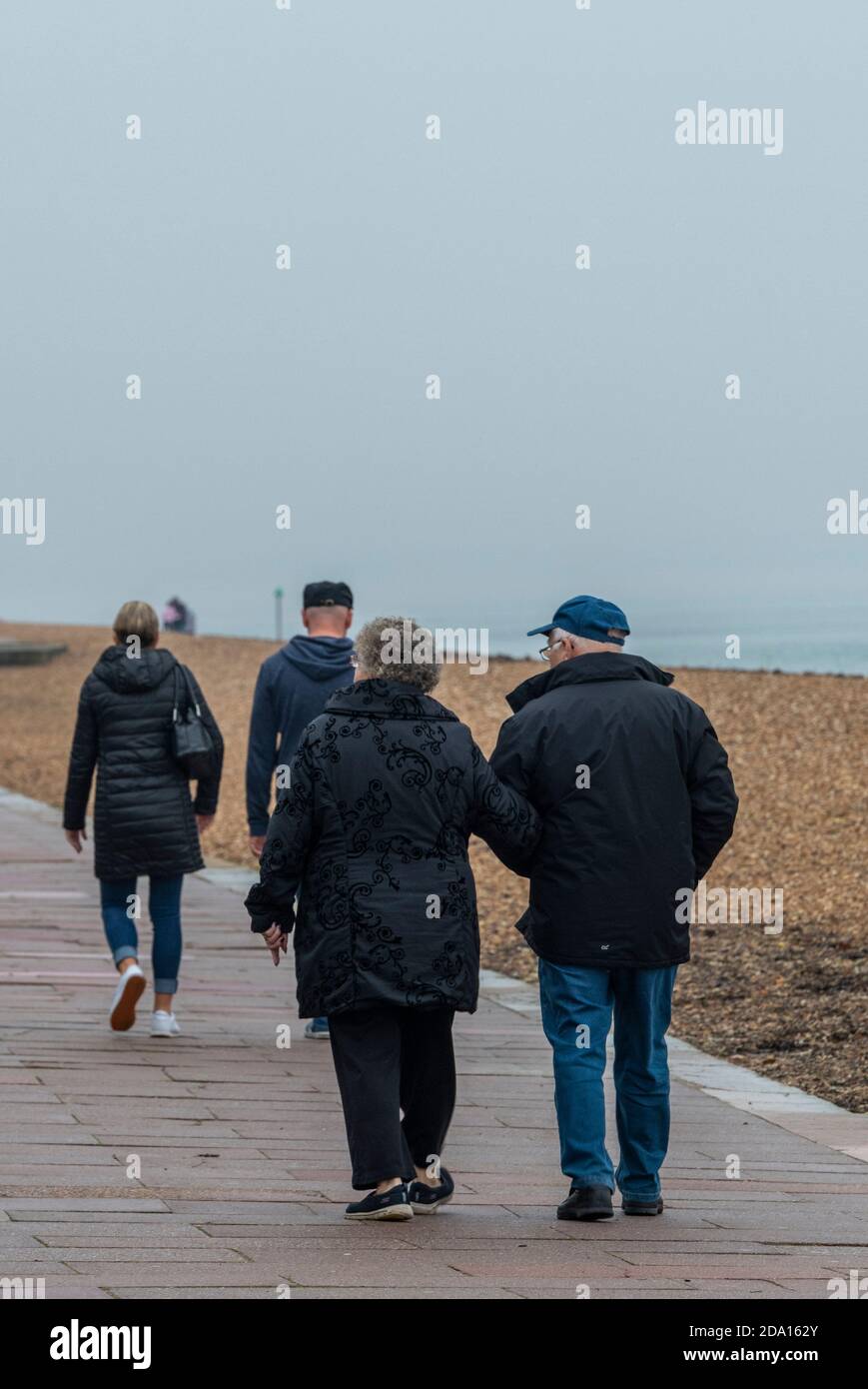 couples walking along the seafront at cowes on the isle of wight Stock Photo