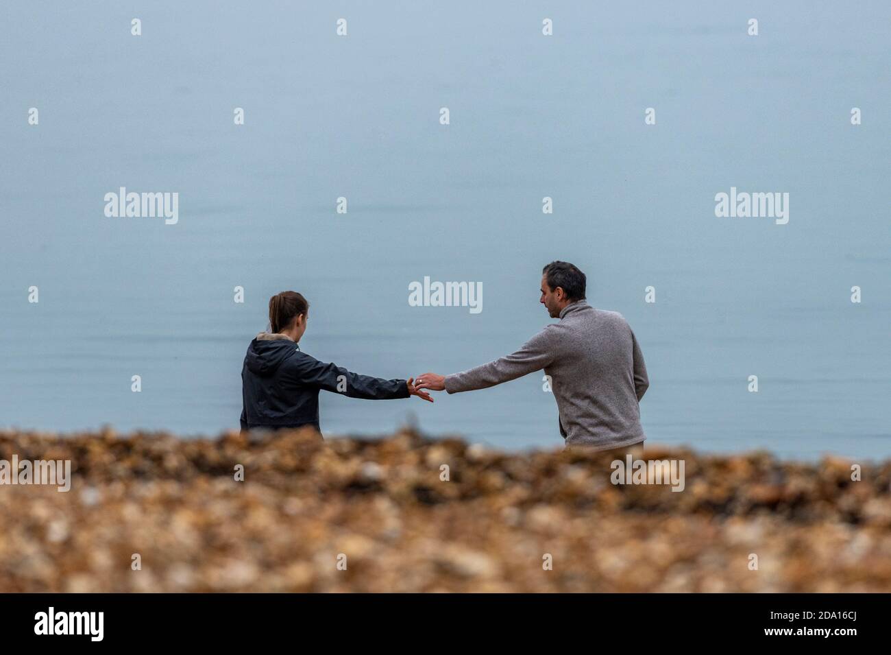 a man and woman lover or couple holding hands on the beach. Stock Photo