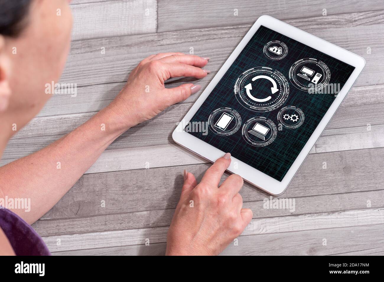 Woman using a tablet showing system update concept Stock Photo