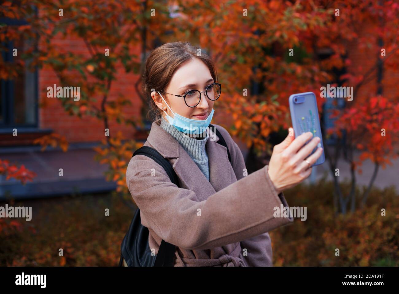 Woman holding smartphone in front of her during video call. Communication with relatives during coronavirus pandemic. Stock Photo