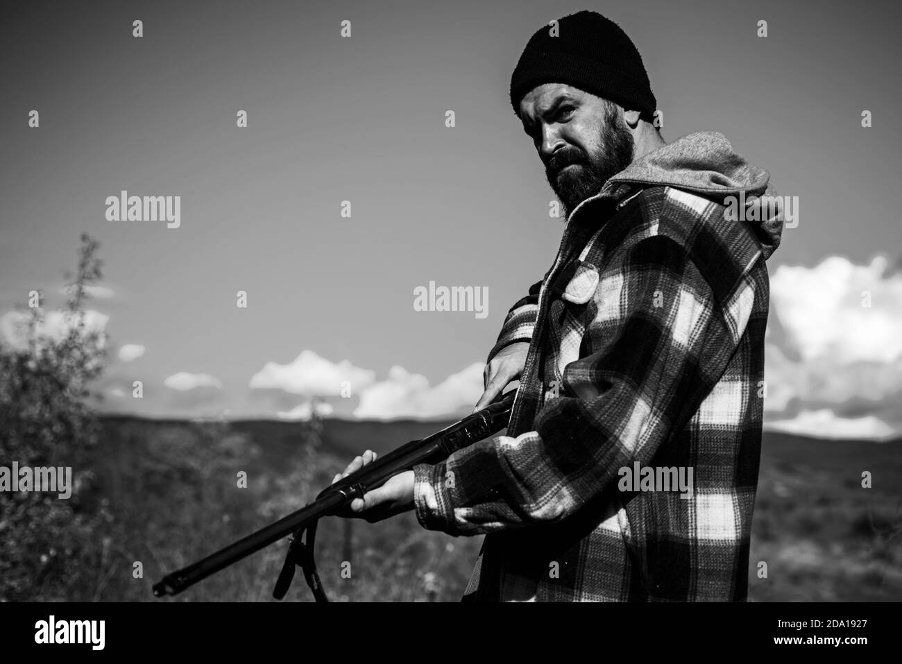 Hunter with shotgun gun on hunt. Hunting without borders. Clothes for the hunter. Close up Portrait of hamdsome Hunter. Stock Photo