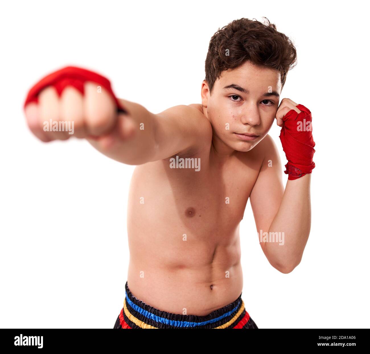 Young kickboxer training shadow boxing, isolated on white background