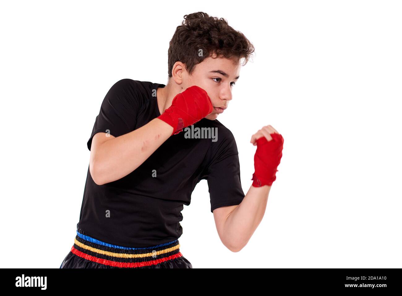 Young kickboxer training shadow boxing, isolated on white background ...
