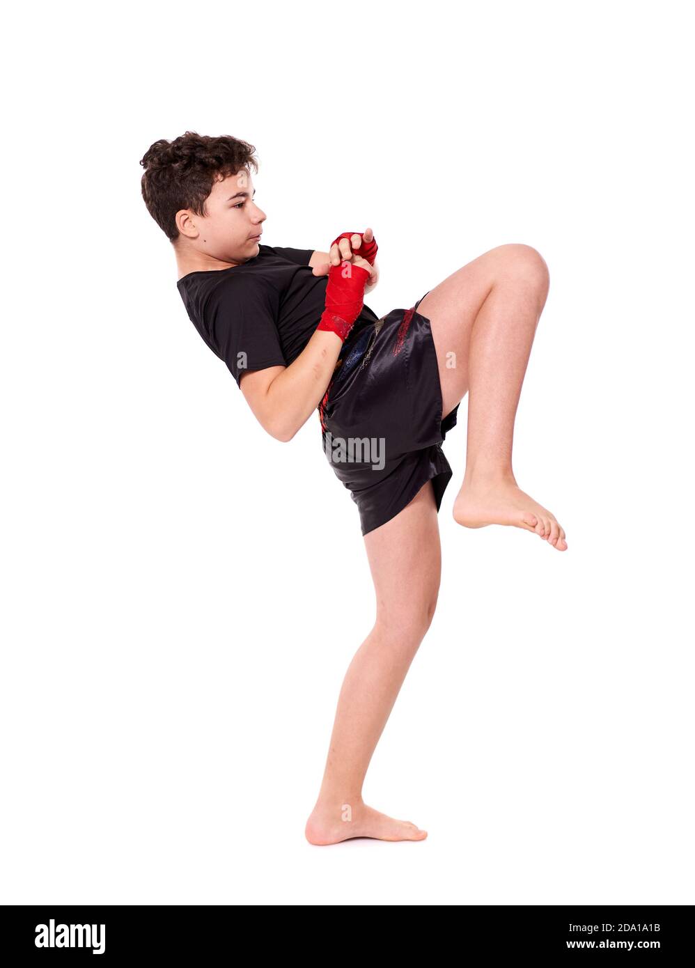 Young kickboxer training shadow boxing, isolated on white background