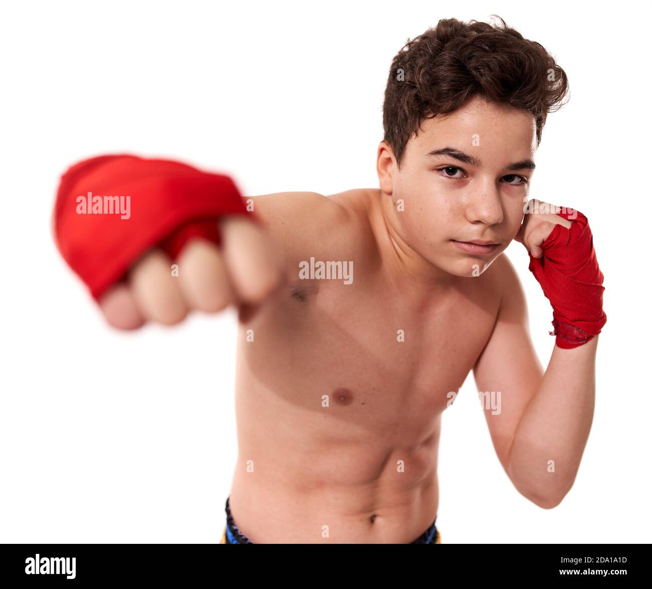 Young kickboxer training shadow boxing, isolated on white background