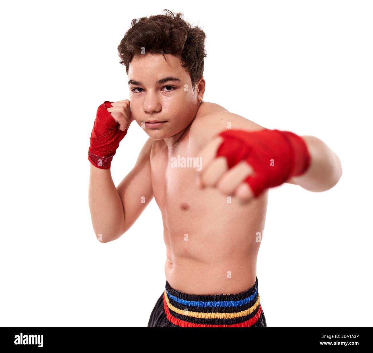 Young kickboxer training shadow boxing, isolated on white background