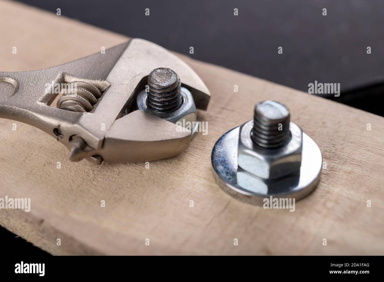 Metal bolts and nuts for joining wood. Tightening the screws with an