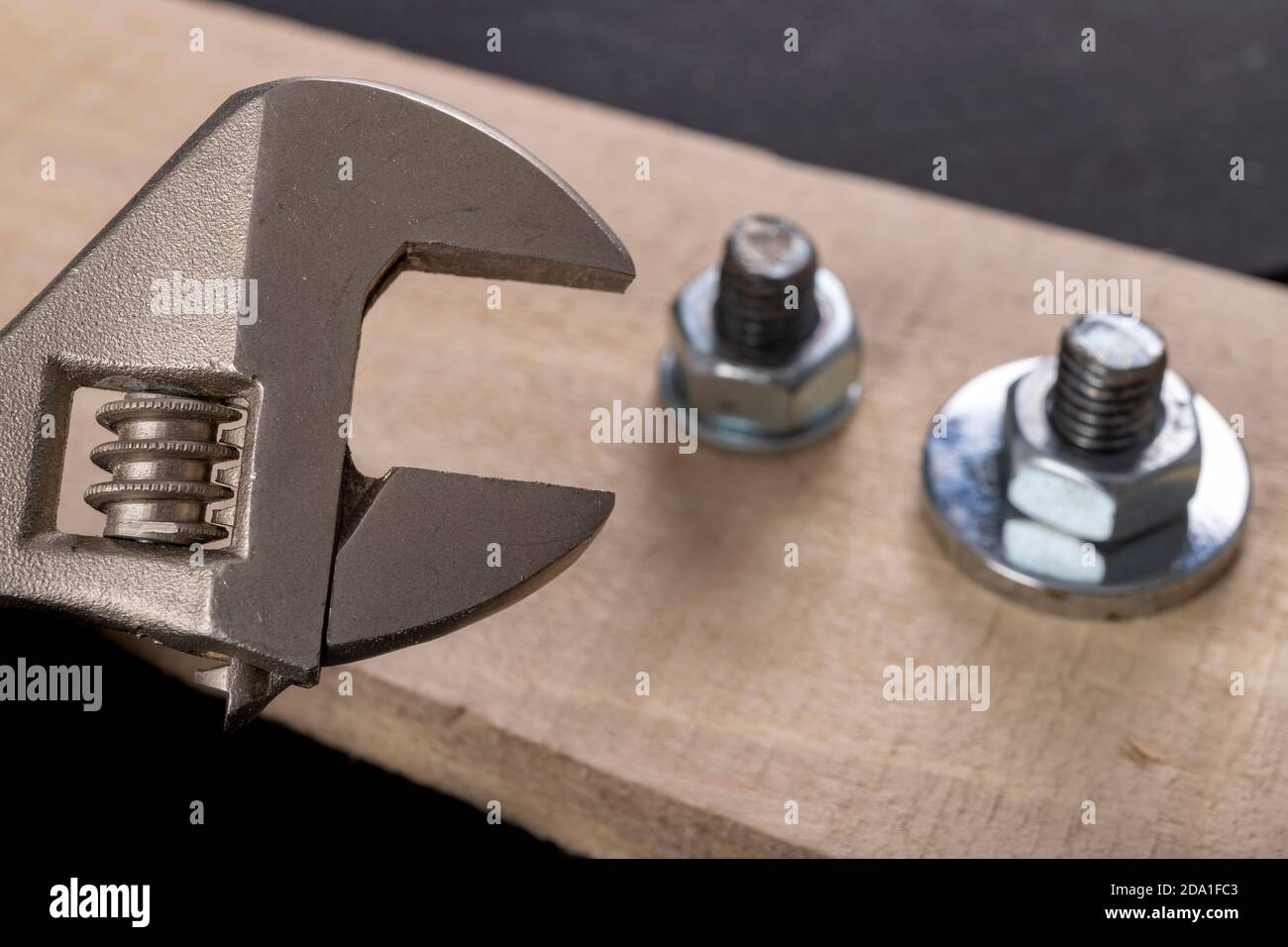 Metal bolts and nuts for joining wood. Tightening the screws with an