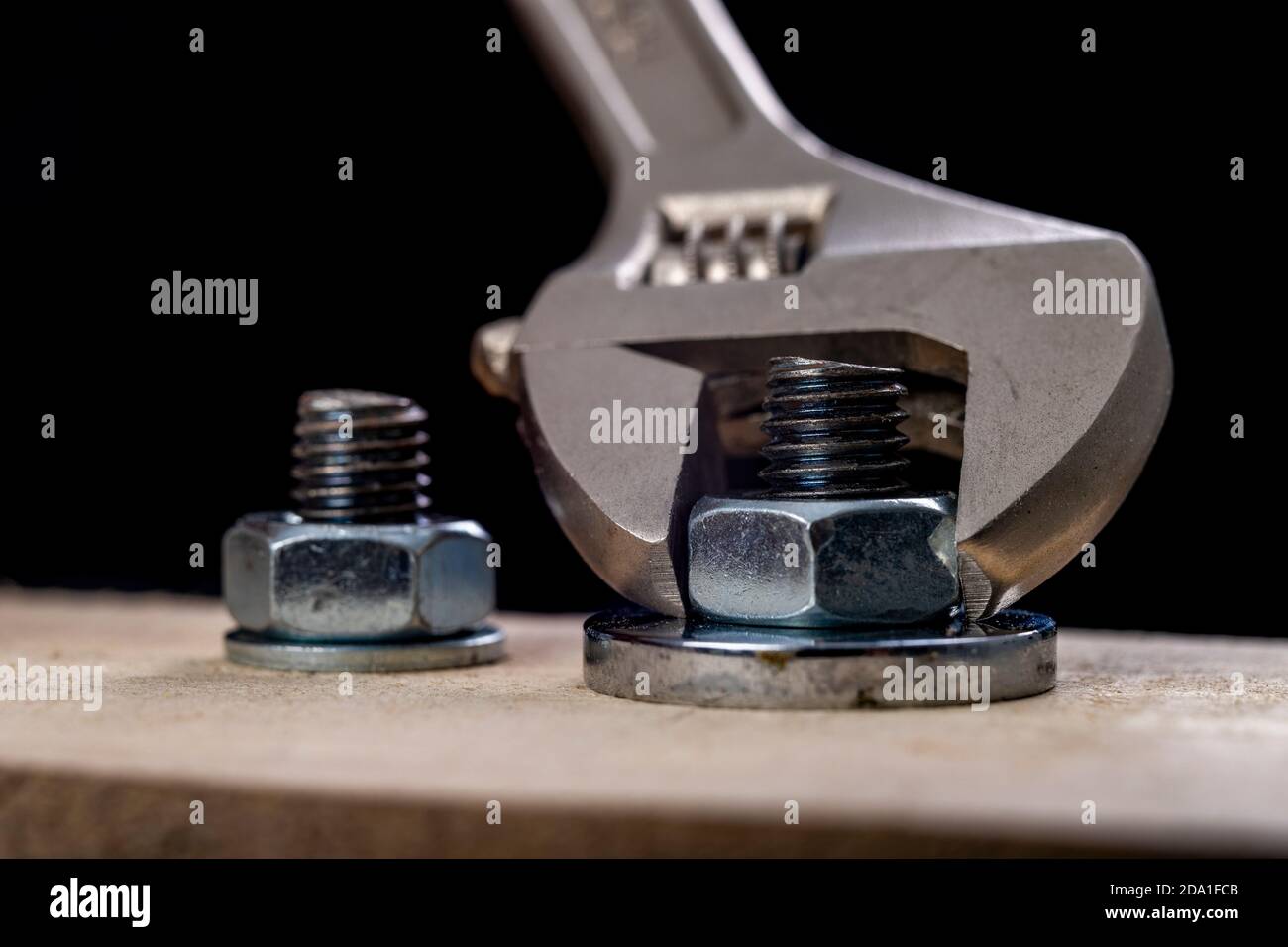 Metal bolts and nuts for joining wood. Tightening the screws with an