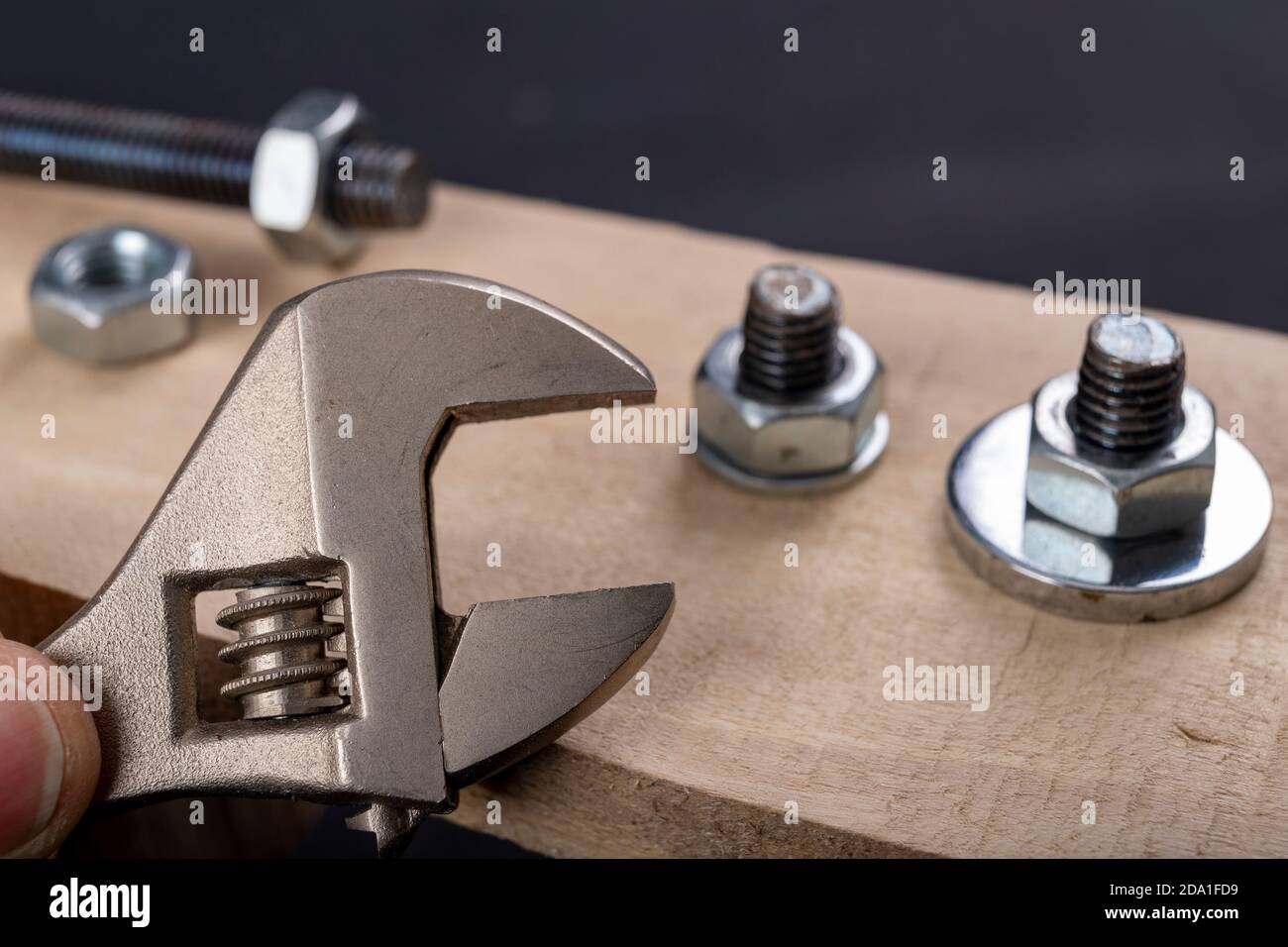 Metal bolts and nuts for joining wood. Tightening the screws with an