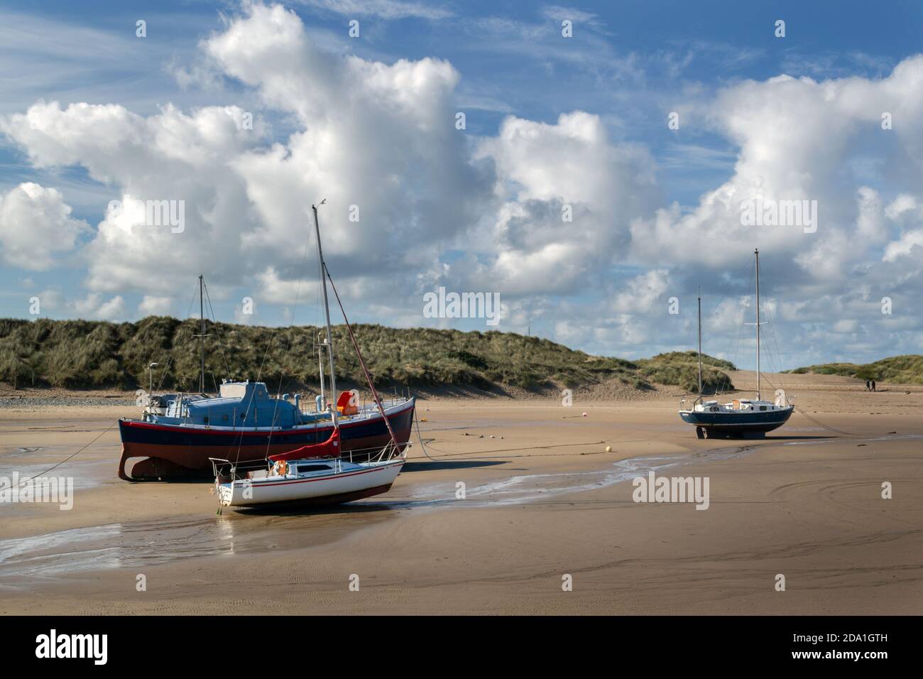 BARMOUTH, WALES - october 1st, 2020: Three boats in the Estuary of the river Mawddach, Barmouth, Wales, County of Gwynedd on a sunny autumn afternoon Stock Photo