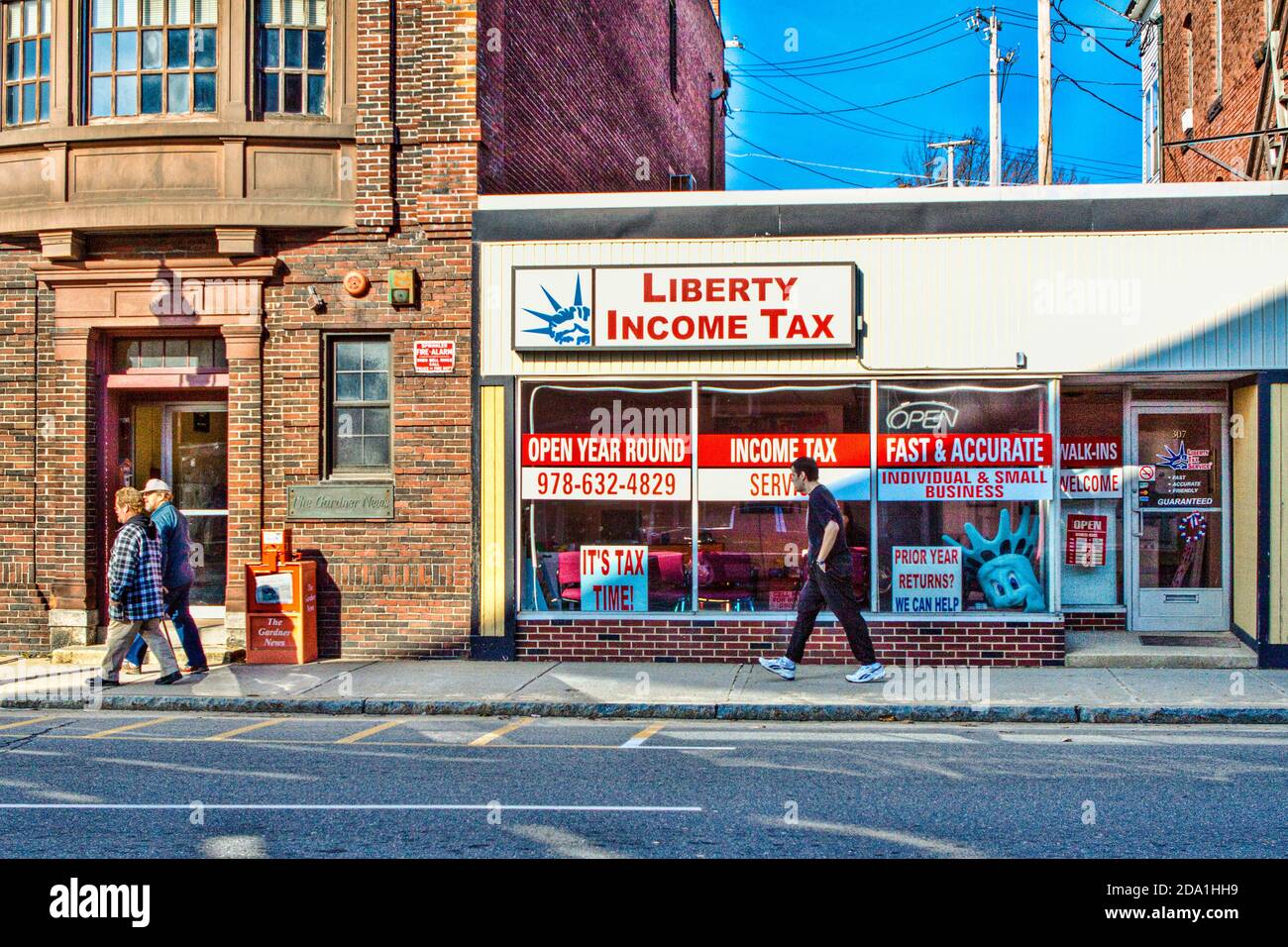 People walking by the Liberty Income Tax business Stock Photo
