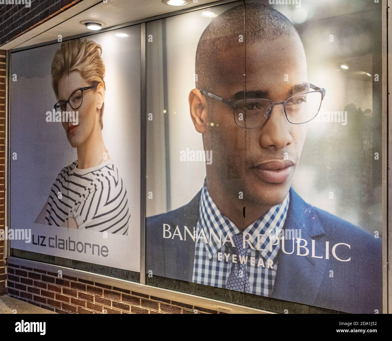 Two faces in a store front window Stock Photo