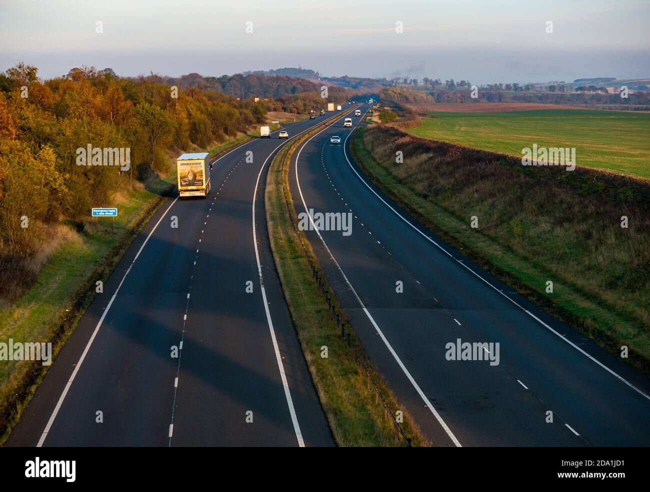 View of A1 dual carriageway at sunset with traffic, East Lothian, Scotland., UK Stock Photo