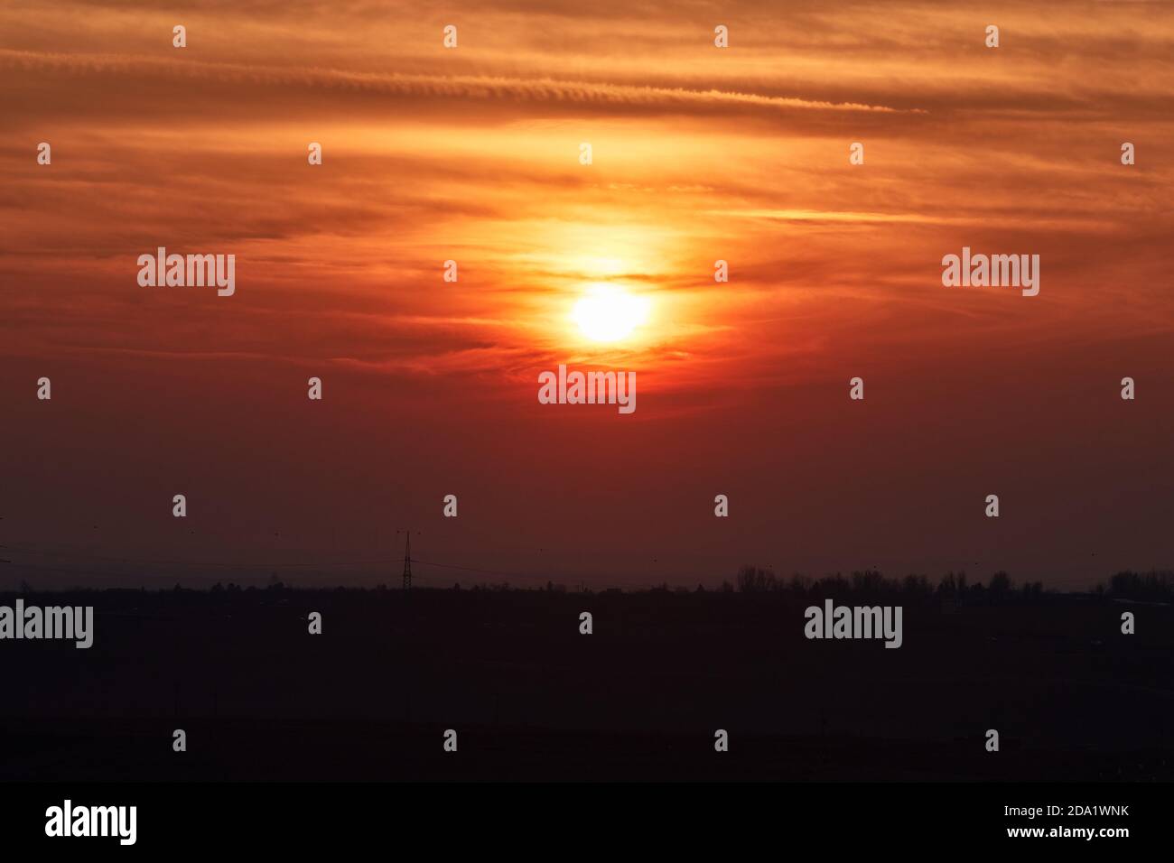 Sunset through cloudy red sky Stock Photo