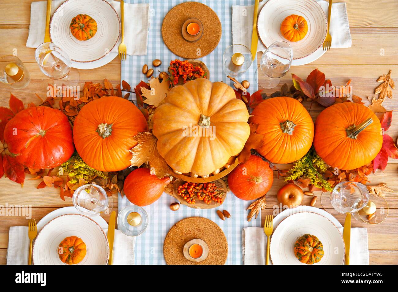 Beautiful table setting with pumpkins and autumn leaves in dining room ...