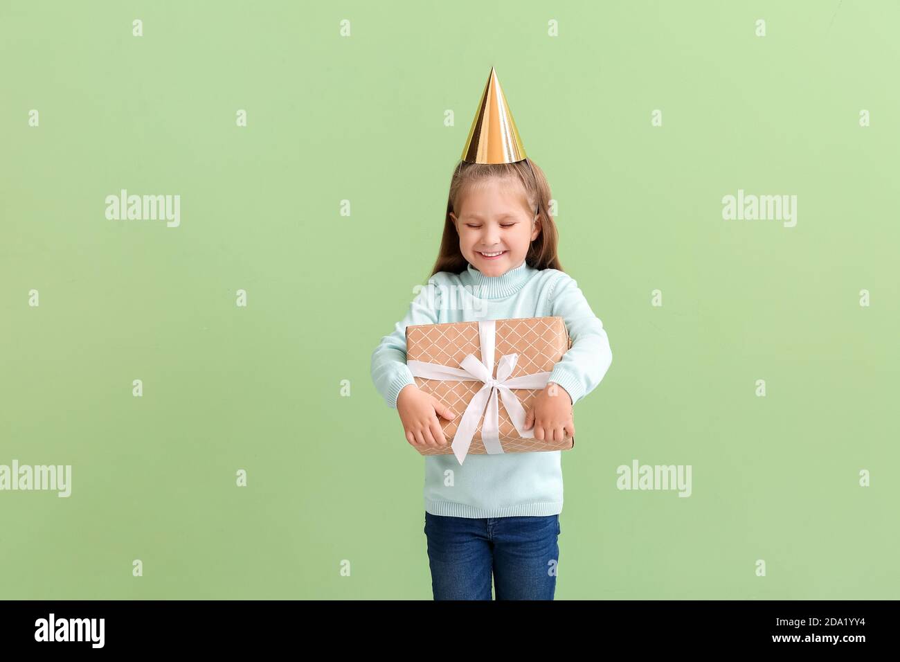 Cute little girl with Birthday gift on color background Stock Photo - Alamy