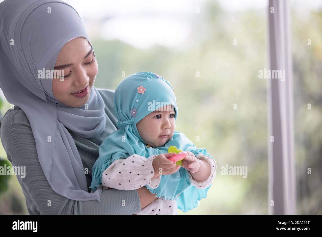 Happy muslim mother holding a beautiful little baby Stock Photo