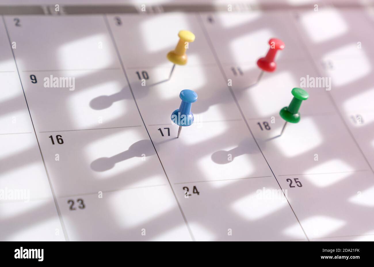 Thumbtacks pin on calendar. Concept for busy schedule. Stock Photo